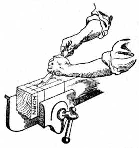 Fig. 184.—Removing Waste of Mortise with Chisel.