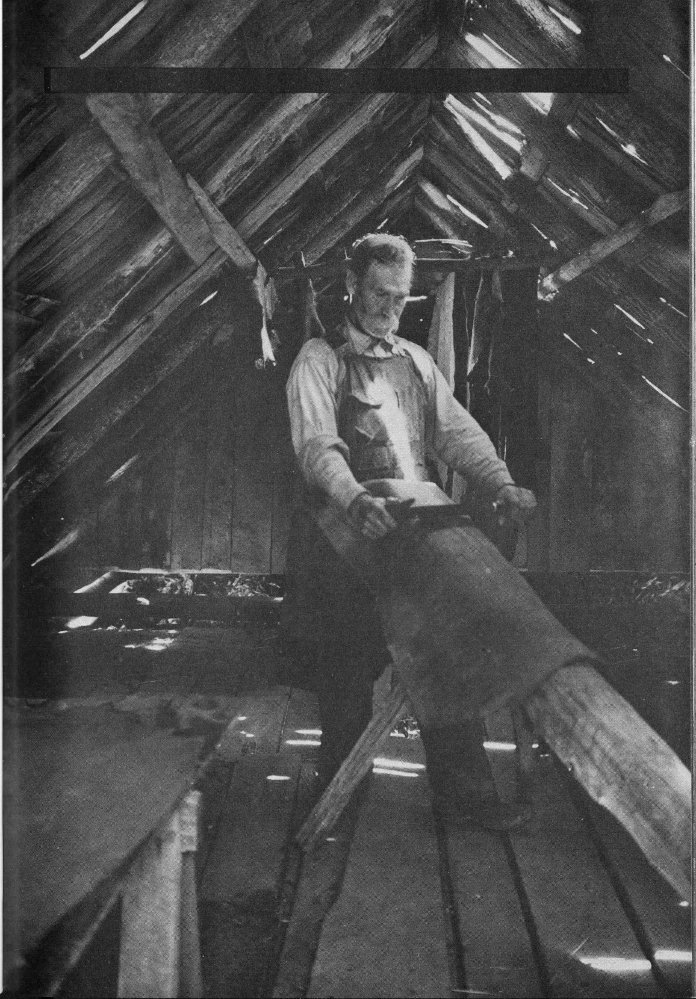 Milas Messer dresses or curries a hide in the drying shed at his farm on Cove Creek.